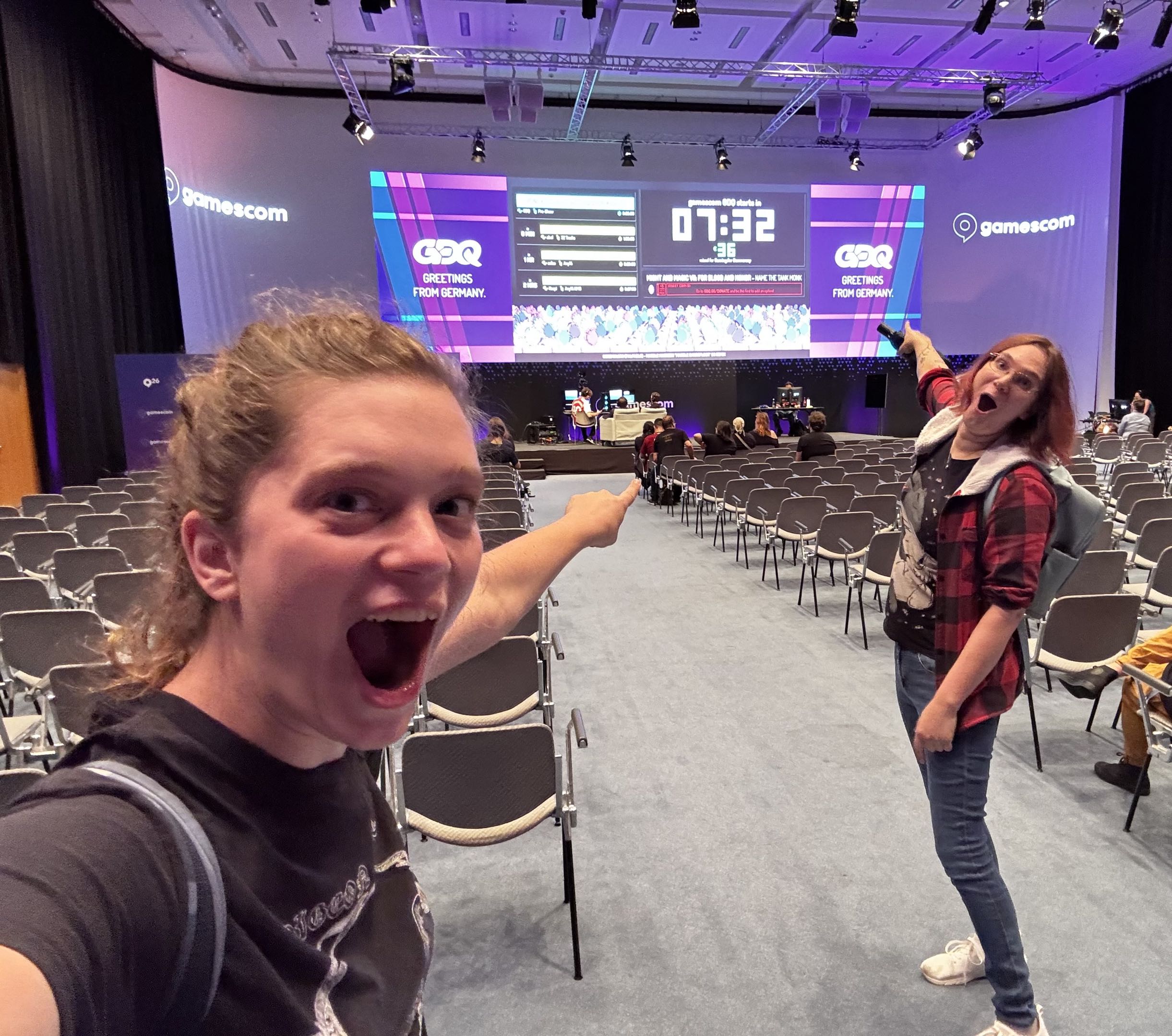 Sophie (left) and Chelsea (right) are excited that GDQ is about to start in 7 minutes and 30 seconds. The room is still quite empty, a lot of chairs are free. Sophie and Chelsea are posing in a way that references animal advocate John Oberg's famous photo with KFC's Beyond Meat chicken.